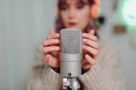 woman performing asmr on professional microphone